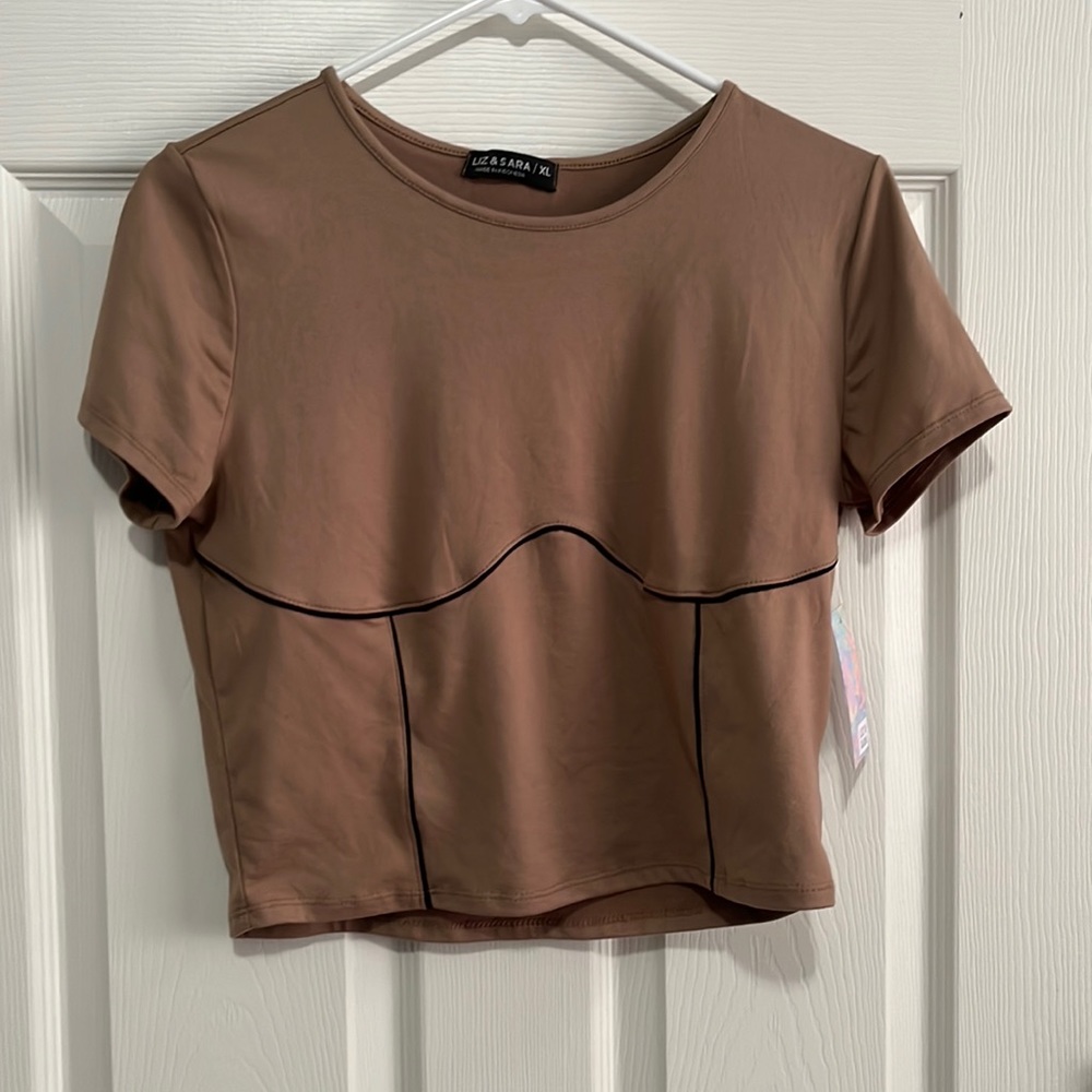 Cropped brown top with black line enhancing the boobs.